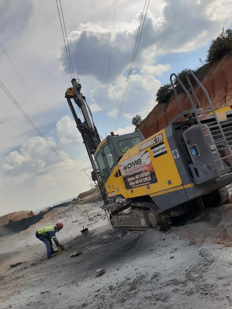 Surface operations on site — bench preparation under live transmission corridor.